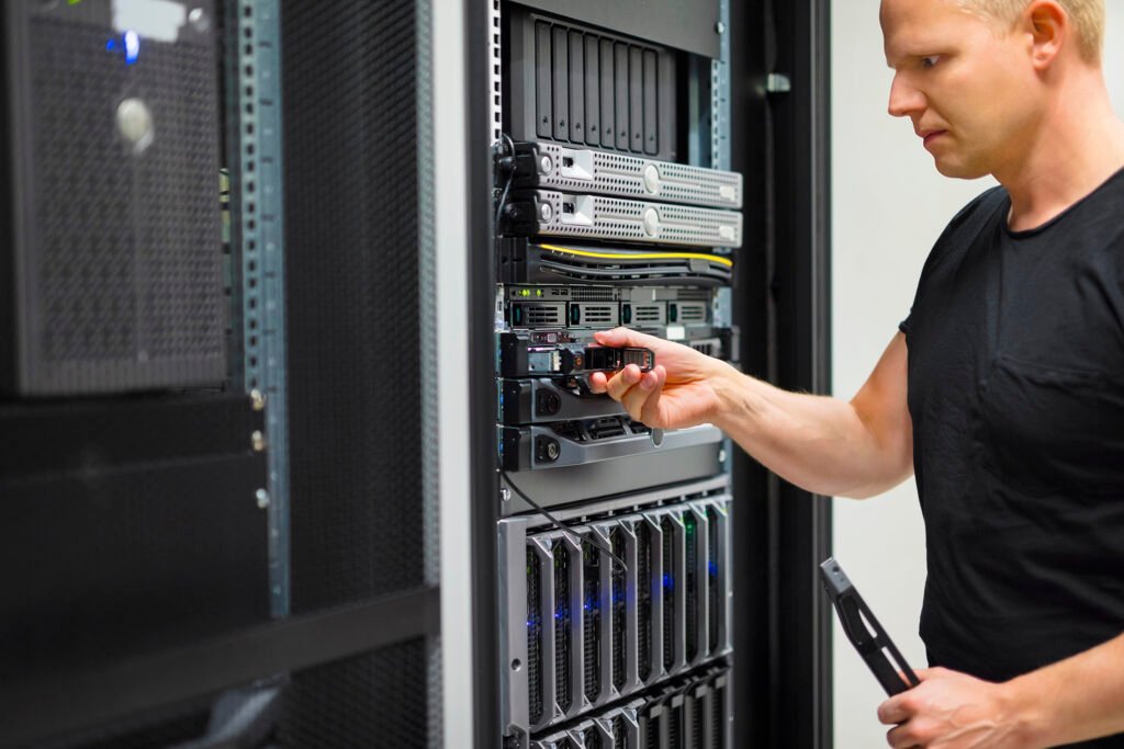 IT Engineer Installing Hard Drive In Rack Server